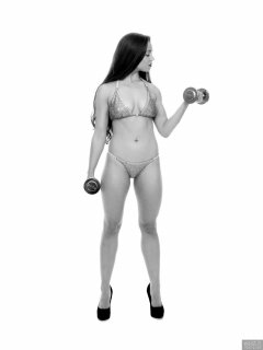 Charlene Joy weightlifting still, in her fitness competition bikini