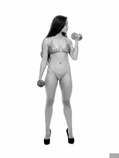 Charlene Joy weightlifting still, in her fitness competition bikini