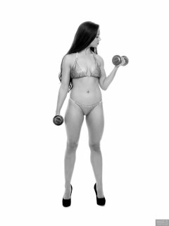 Charlene Joy weightlifting still, in her fitness competition bikini