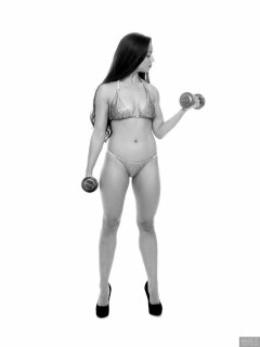 Charlene Joy weightlifting still, in her fitness competition bikini