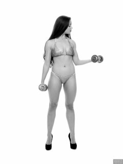 Charlene Joy weightlifting still, in her fitness competition bikini