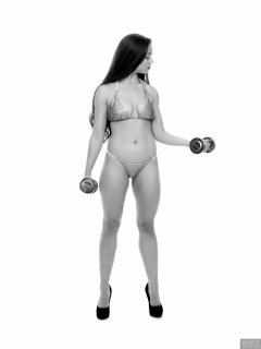Charlene Joy weightlifting still, in her fitness competition bikini
