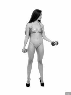 Charlene Joy weightlifting still, in her fitness competition bikini