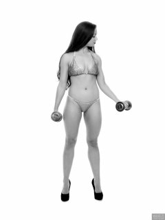 Charlene Joy weightlifting still, in her fitness competition bikini