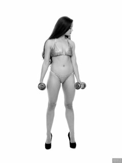Charlene Joy weightlifting still, in her fitness competition bikini