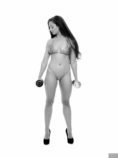 Charlene Joy weightlifting still, in her fitness competition bikini