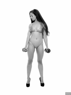 Charlene Joy weightlifting still, in her fitness competition bikini