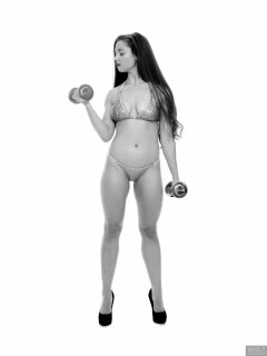Charlene Joy weightlifting still, in her fitness competition bikini