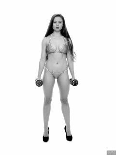 Charlene Joy weightlifting still, in her fitness competition bikini