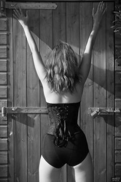2018-07-25 Twinklenose, in the garden, in tightly-laced black underbust corset worn over black bra and black pantie girdle, worn as hotpants