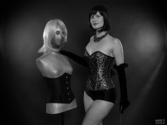 2018-09-16 Saffine posing with corsetted silver droid, in her own silver and black tightly-laced corset, black boob tube and black Style 210 pantie girdle worn as hotpants