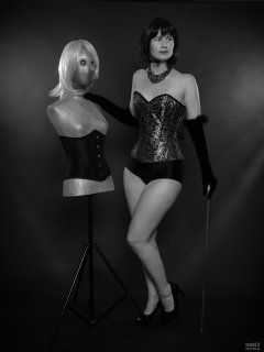 2018-09-16 Saffine posing with corsetted silver droid, in her own silver and black tightly-laced corset, black boob tube and black Style 210 pantie girdle worn as hotpants