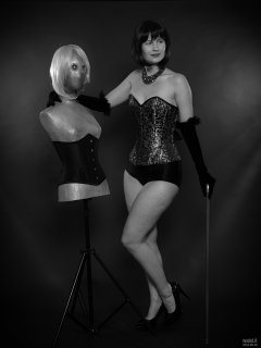2018-09-16 Saffine posing with corsetted silver droid, in her own silver and black tightly-laced corset, black boob tube and black Style 210 pantie girdle worn as hotpants