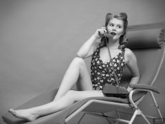 2018-11-04 Sophie Pixie poses on Relaxator 365 lounger chair, using red Trimphone, wearing red and gold vintage tummy-control one-piece swimsuit