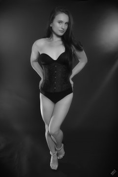 2019-09-21 Kristine Gold - in tightly-laced black underbust corset worn over black Miraclesuit strapless one-piece bodyshaper
