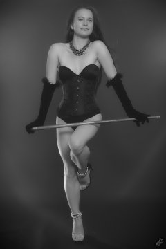 2019-09-21 Kristine Gold - in tightly-laced black underbust corset worn over black Miraclesuit strapless one-piece bodyshaper