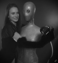 2019-09-21 Kristine Gold - in tightly-laced black underbust corset worn over black Miraclesuit strapless one-piece bodyshaper