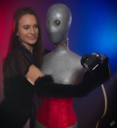 2019-09-21 Kristine Gold - in tightly-laced black underbust corset worn over black Miraclesuit strapless one-piece bodyshaper