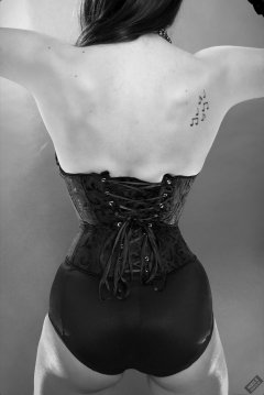 2020-02-02 Jessica Maria in tightly-laced black underbust corset, worn over black Miraclesuit bodyshaper - rear view
