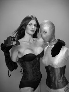 2020-03-08 LisaAnne in tightly-laced black underbust corset, worn over black Miraclesuit bodyshaper