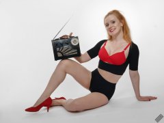 Rebecca Love - plays with vintage Roamer Ten multiband radio, whilst modelling black posture top, red bra and lycra control briefs, worn as hotpants