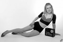 Rebecca Love - plays with vintage Roamer Ten multiband radio, whilst modelling black posture top, red bra and lycra control briefs, worn as hotpants