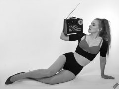 Rebecca Love - plays with vintage Roamer Ten multiband radio, whilst modelling black posture top, red bra and lycra control briefs, worn as hotpants
