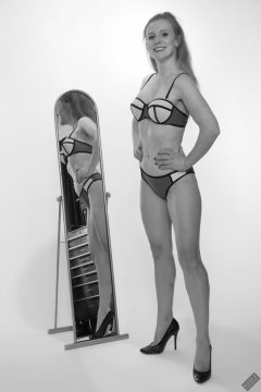 Rebecca Love - playing with 120cm mirrors, in a blue multi-coloured neoprene bikini