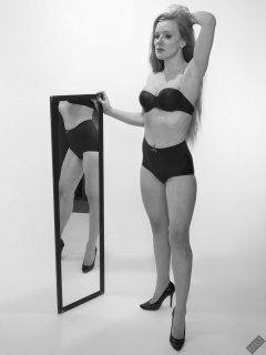 Rebecca Love - with blue-framed 120 cm mirrors,  wearing matching blue bra and vintage-style pantie girdle