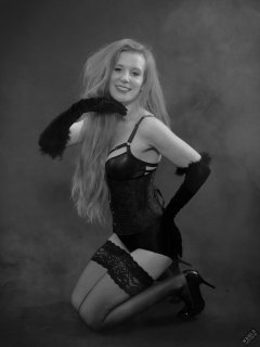 Rebecca Love - tightly-laced black underbust corset, with black wetlook bra and shinly black high-waist girdle worn as hotpants