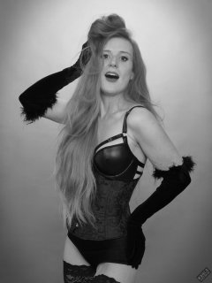Rebecca Love - tightly-laced black underbust corset, with black wetlook bra and shinly black high-waist girdle worn as hotpants