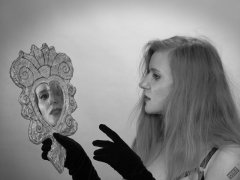 Rebecca Love - poses with hand-held mirror