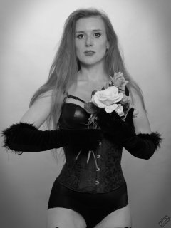 Rebecca Love - tightly-laced black underbust corset, with black wetlook bra and shinly black high-waist girdle worn as hotpants