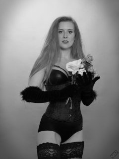Rebecca Love - tightly-laced black underbust corset, with black wetlook bra and shinly black high-waist girdle worn as hotpants