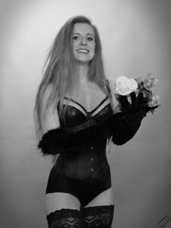 Rebecca Love - tightly-laced black underbust corset, with black wetlook bra and shinly black high-waist girdle worn as hotpants