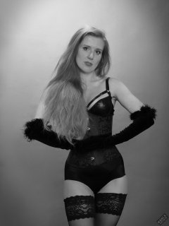 Rebecca Love - tightly-laced black underbust corset, with black wetlook bra and shinly black high-waist girdle worn as hotpants