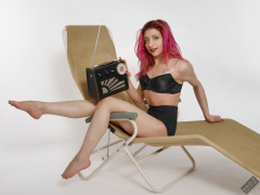 2022-07-02 Mave D models black bra top and vintage girdle worn as hotpants, whilst relaxing in vintage Relaxator 365 chair and listening to Roamer Ten radio