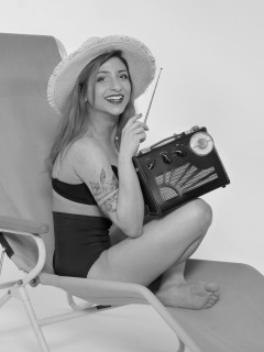 2022-07-02 Mave D models black bra top and vintage girdle worn as hotpants, whilst relaxing in vintage Relaxator 365 chair and listening to Roamer Ten radio