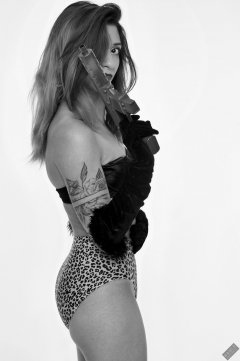 Mave D in black bra top and opera cloves, and tight stretchy animal print control briefs worn as hotpants