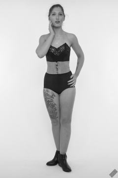 Michelle's Modelling in black strapless bra-top and matching black high-waist girdle, worn as hotpants, c/w tight leather corset-belt