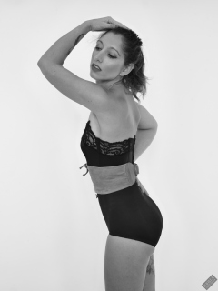 Michelle's Modelling in black strapless bra-top and matching black high-waist girdle, worn as hotpants, c/w tight leather corset-belt