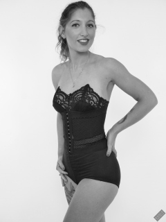 Michelle's Modelling in black strapless bra-top and matching black high-waist girdle, worn as hotpants, c/w tight leather corset-belt