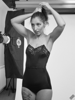 Michelle's Modelling in black strapless bra-top and matching black high-waist girdle, worn as hotpants, c/w tight leather corset-belt