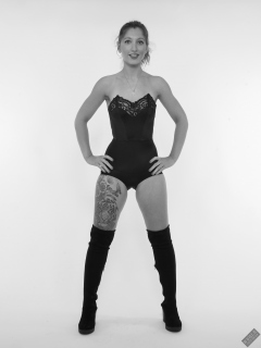 Michelle's Modelling in black strapless bra-top and matching black high-waist girdle, worn as hotpants, c/w tight leather corset-belt