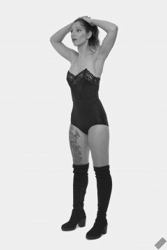 Michelle's Modelling in black strapless bra-top and matching black high-waist girdle, worn as hotpants, c/w tight leather corset-belt
