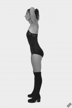 Michelle's Modelling in black strapless bra-top and matching black high-waist girdle, worn as hotpants, c/w tight leather corset-belt