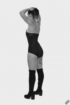 Michelle's Modelling in black strapless bra-top and matching black high-waist girdle, worn as hotpants, c/w tight leather corset-belt