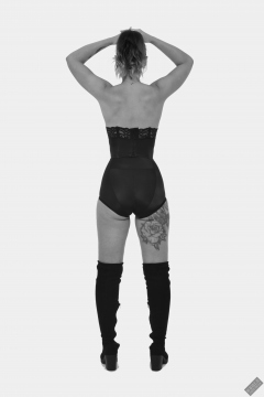 Michelle's Modelling in black strapless bra-top and matching black high-waist girdle, worn as hotpants, c/w tight leather corset-belt