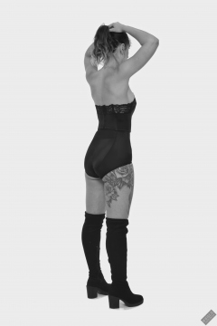 Michelle's Modelling in black strapless bra-top and matching black high-waist girdle, worn as hotpants, c/w tight leather corset-belt