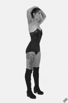 Michelle's Modelling in black strapless bra-top and matching black high-waist girdle, worn as hotpants, c/w tight leather corset-belt